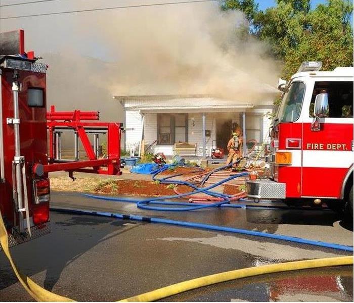 Image of fire fighters fighting a home fire