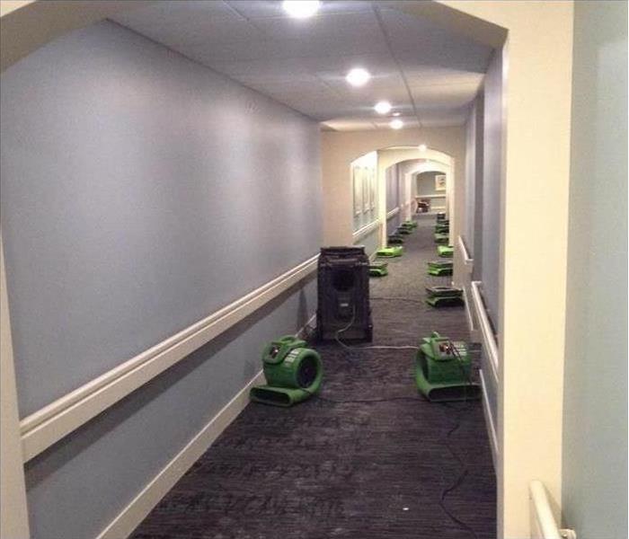 SERVPRO drying equipment placed on carpet floor in business hall