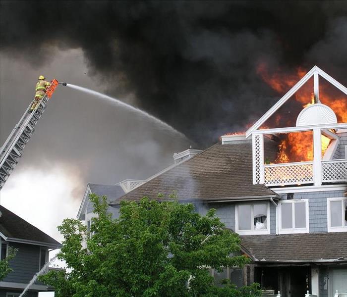 Image of fire fighters putting out a home fire 